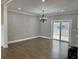 Dining room with chandelier and hardwood floors, open to a deck and backyard at 85 Prestwick Pl, Walterboro, SC 29488