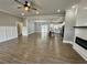 Spacious living room with hardwood floors, shiplap fireplace, and a view into the kitchen at 85 Prestwick Pl, Walterboro, SC 29488