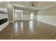 Entryway and living room featuring paneled accent walls, hardwood floors and modern fireplace at 85 Prestwick Pl, Walterboro, SC 29488