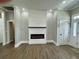 Bright living room with fireplace, wood floors, and white trim at 85 Prestwick Pl, Walterboro, SC 29488