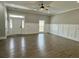 Entryway and living room featuring paneled accent walls, hardwood floors and a ceiling fan at 85 Prestwick Pl, Walterboro, SC 29488