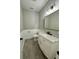 Stylish powder room with marble countertop, white vanity, and modern mirror at 85 Prestwick Pl, Walterboro, SC 29488