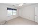 Bright bedroom with neutral walls and plush carpeting, featuring window with blinds and doorway at 874 Law Ln, Mount Pleasant, SC 29464