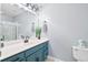 Bright bathroom featuring blue vanity, modern fixtures, and a glass-enclosed shower at 8741 Grassy Oak Trl, North Charleston, SC 29420