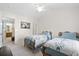Bright bedroom featuring twin beds with matching spreads, ceiling fan, and ensuite bathroom at 8741 Grassy Oak Trl, North Charleston, SC 29420