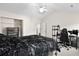 Spacious bedroom with vaulted ceiling, ceiling fan, large bed, and a gaming setup at 8741 Grassy Oak Trl, North Charleston, SC 29420