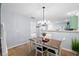 Bright dining room with wooden table and chairs beneath a modern chandelier fixture at 8741 Grassy Oak Trl, North Charleston, SC 29420