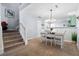 Cozy dining area featuring a wooden table and view of the carpeted stairs at 8741 Grassy Oak Trl, North Charleston, SC 29420