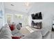 Bright living room featuring neutral-toned furniture and a large window and vaulted ceiling at 8741 Grassy Oak Trl, North Charleston, SC 29420