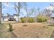 Large backyard with a tree and grassy areas with a fenced border at 914 Aleppo Dr, Ladson, SC 29456