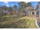 A well-maintained backyard with lush green grass and a black metal fence, providing privacy and a secure outdoor space at 9394 Harroway Rd, Summerville, SC 29485