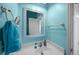 Powder room with a white sink, a decorative mirror, and blue-painted walls at 9394 Harroway Rd, Summerville, SC 29485