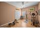 A peach-colored room has workout equipment and a ceiling fan, offering space for fitness and relaxation at 9394 Harroway Rd, Summerville, SC 29485