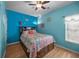 Bedroom with wooden floors, a ceiling fan and colorfully decorated queen bed at 9394 Harroway Rd, Summerville, SC 29485