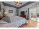 Bedroom with hardwood floors, TV, and a sliding glass door to a patio at 9394 Harroway Rd, Summerville, SC 29485