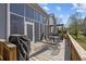 A lovely deck features a table and chairs and a BBQ, with an umbrella for shade, creating an inviting outdoor space at 9394 Harroway Rd, Summerville, SC 29485