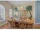 Elegant dining room featuring a wooden table, chairs, and a hutch with palm tree accents at 9394 Harroway Rd, Summerville, SC 29485