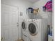 Convenient laundry room equipped with washer, dryer and shelving at 9394 Harroway Rd, Summerville, SC 29485