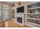 Living room features a fireplace with built-in shelves and hardwood floors at 9394 Harroway Rd, Summerville, SC 29485