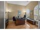Comfortable office with hardwood floors, arched window, and furniture at 9394 Harroway Rd, Summerville, SC 29485