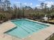 Aerial view of a swimming pool with fountain pond and trees in the background at 9394 Harroway Rd, Summerville, SC 29485