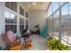 Cozy sunroom with floor to ceiling windows and comfortable seating at 9394 Harroway Rd, Summerville, SC 29485