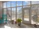 Bright sunroom with tiled floors and access to the outdoor deck at 9394 Harroway Rd, Summerville, SC 29485