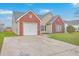 Inviting home with a well-kept lawn, attached garage, and combination of brick and vinyl siding at 99 Dovetail Cir, Summerville, SC 29483