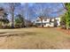 Large backyard featuring a manicured lawn and a view of the home's exterior at 1032 Black Rush Cir, Mount Pleasant, SC 29466
