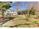 Expansive backyard with a lush green lawn and a charming two-story home in the background at 1032 Black Rush Cir, Mount Pleasant, SC 29466