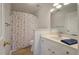 Bright bathroom featuring a large mirror, white vanity, and a shower with a floral curtain at 1032 Black Rush Cir, Mount Pleasant, SC 29466