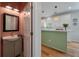 Charming half-bathroom with a sink and vanity, alongside a view into the bright, updated kitchen at 1032 Black Rush Cir, Mount Pleasant, SC 29466