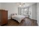 Cozy bedroom featuring hardwood floors, a bay window, a ceiling fan, and wood dresser at 1032 Black Rush Cir, Mount Pleasant, SC 29466