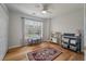 Charming bedroom features wood floors, a ceiling fan, table, and bright window at 1032 Black Rush Cir, Mount Pleasant, SC 29466