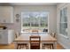 Bright dining area with a wooden table and chairs set by a large window offering views of the outdoor space at 1032 Black Rush Cir, Mount Pleasant, SC 29466