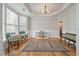 Bright living room featuring hardwood floors, a decorative rug, and ample seating, bathed in natural light from large windows at 1032 Black Rush Cir, Mount Pleasant, SC 29466