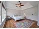 Cozy main bedroom featuring a comfortable bed, a ceiling fan, and a chair in the corner at 1032 Black Rush Cir, Mount Pleasant, SC 29466