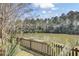 Scenic pond view featuring a wooden fence and lush vegetation in a beautiful environment at 1032 Black Rush Cir, Mount Pleasant, SC 29466
