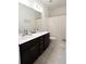 Bathroom featuring a double vanity with dark cabinets, large mirror, and neutral-toned decor at 112 Edisto Crossing Ct, Ridgeville, SC 29472
