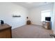 Neutral bedroom featuring a modern desk and shelving units; ready for personalization and comfort at 112 Edisto Crossing Ct, Ridgeville, SC 29472