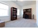 Bright bonus room featuring carpet, a bookcase, a desk, and two windows offering ample natural light at 112 Edisto Crossing Ct, Ridgeville, SC 29472