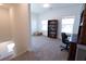 Versatile bonus room with carpet, two windows, and a bookcase for storage or display at 112 Edisto Crossing Ct, Ridgeville, SC 29472