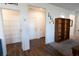 Bright entryway featuring wood-look floors, white walls, access to pantry, and an entrance with white doors at 112 Edisto Crossing Ct, Ridgeville, SC 29472