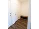 Entryway featuring wood-look floors, neutral walls, and a wooden bench with black storage cubes at 112 Edisto Crossing Ct, Ridgeville, SC 29472