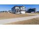 Charming two-story home with gray siding, a two car garage, and a well-manicured lawn at 112 Edisto Crossing Ct, Ridgeville, SC 29472