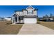 Gorgeous two-story home with gray siding, two car garage, charming curb appeal, and well-kept lawn at 112 Edisto Crossing Ct, Ridgeville, SC 29472