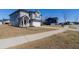 Inviting two-story home with gray siding, a two-car garage, sidewalk and beautiful landscaping at 112 Edisto Crossing Ct, Ridgeville, SC 29472