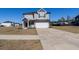 Beautiful two-story home with gray siding, an attached garage, a walkway, and nice landscaping at 112 Edisto Crossing Ct, Ridgeville, SC 29472