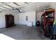 Well-lit garage featuring a concrete floor, storage shelving, a deep freezer, and a roll-up door at 112 Edisto Crossing Ct, Ridgeville, SC 29472