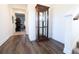Elegant hallway showcasing hardwood floors, a display cabinet, and staircase leading to the upper level at 112 Edisto Crossing Ct, Ridgeville, SC 29472